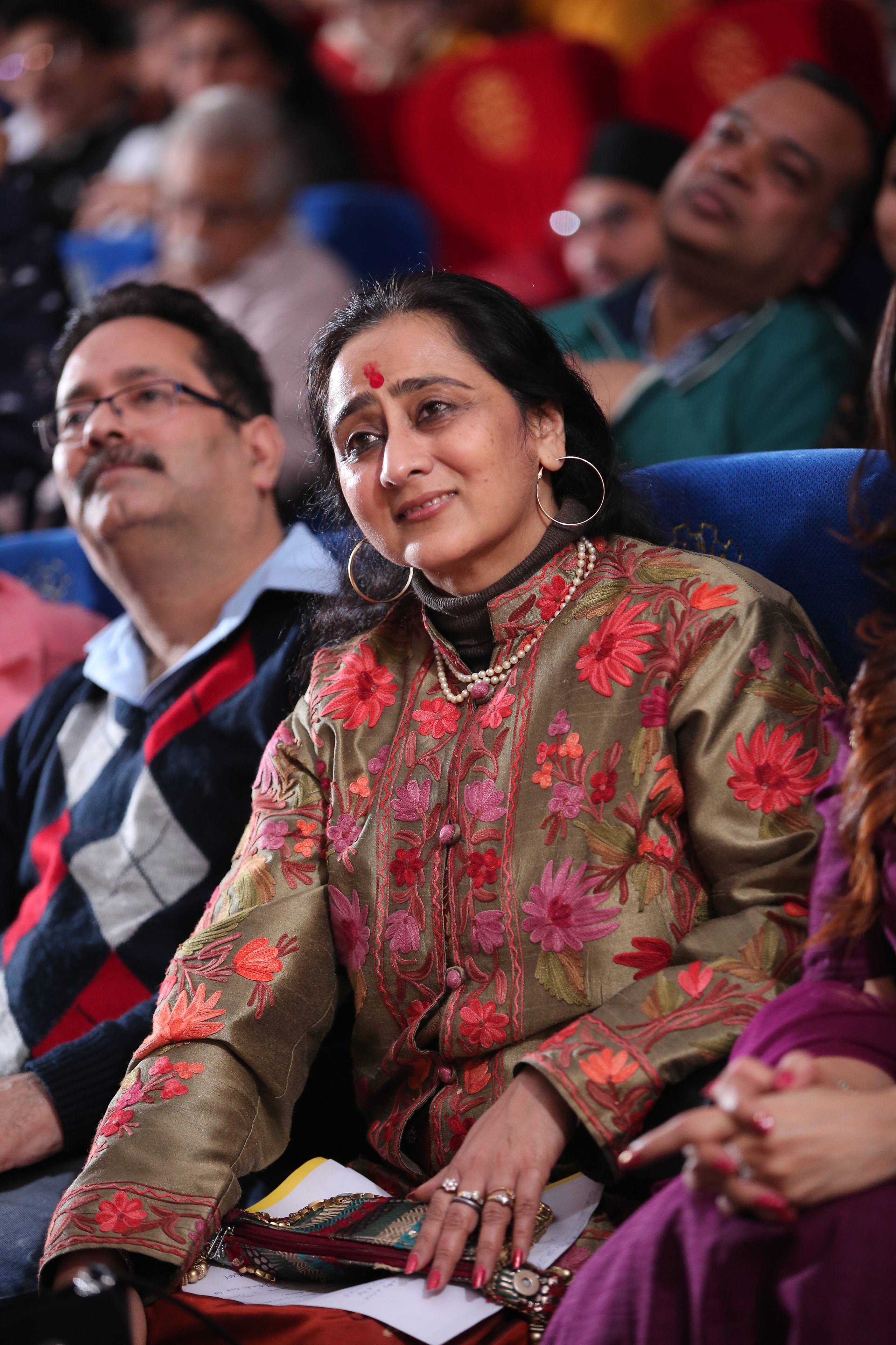 Teacher watching performance at cultural event