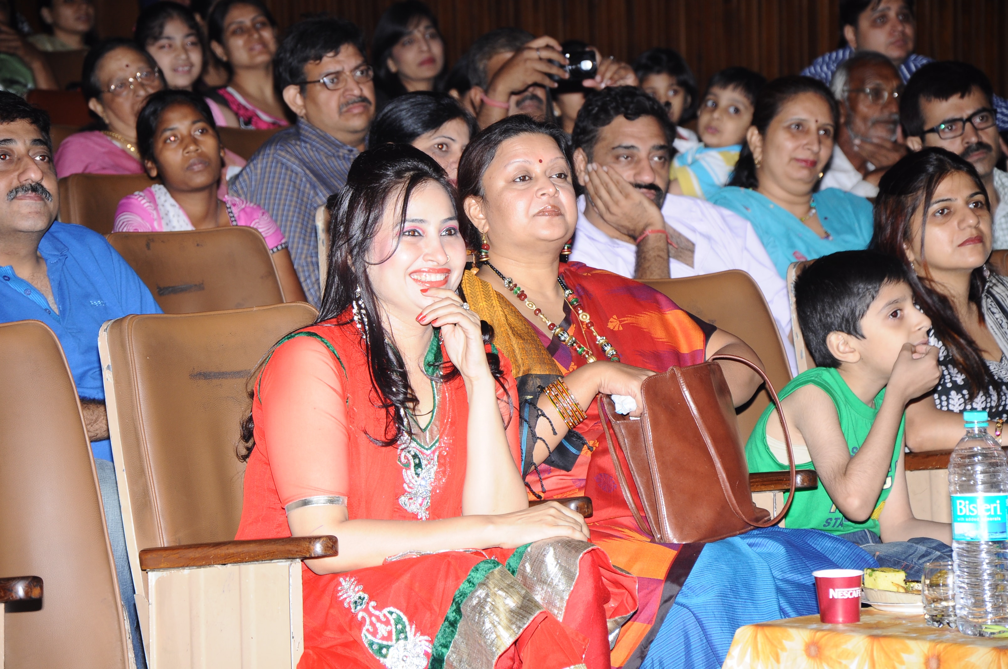 Families and audience watching dance performance