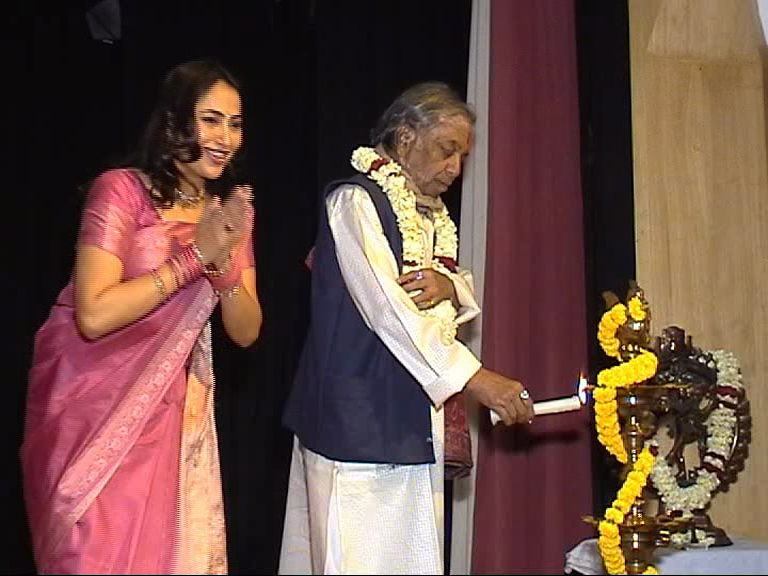 Diya lighting ceremony at cultural dance event