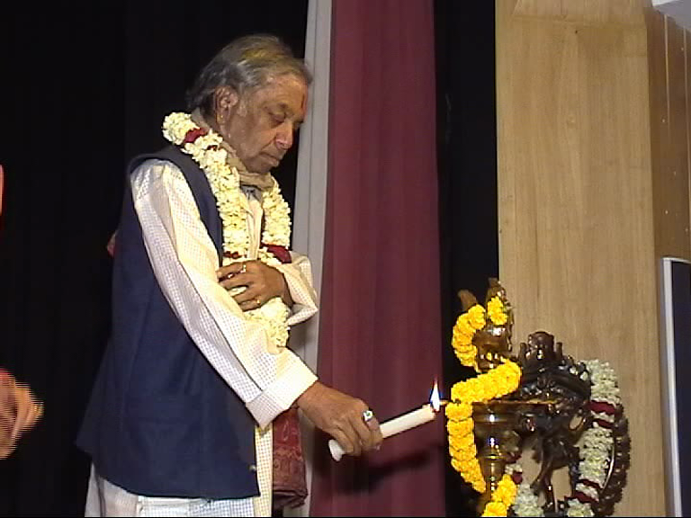 Elder lighting ceremonial diya at academy inauguration