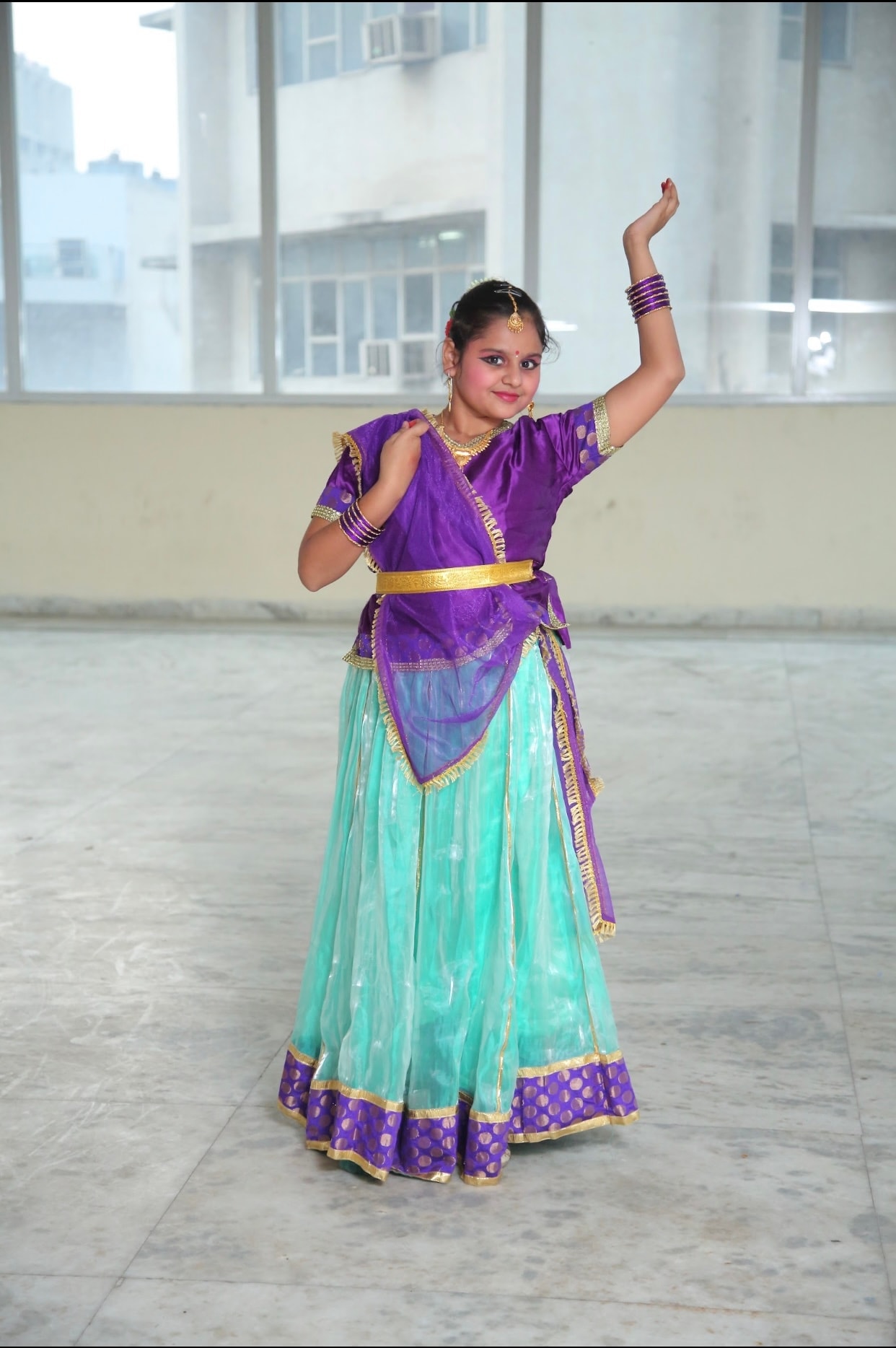 Young student in purple and turquoise Indian dance costume
