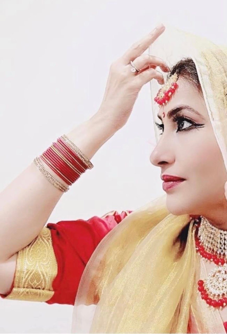 Kathak dancer in red and gold expressive mudra close-up