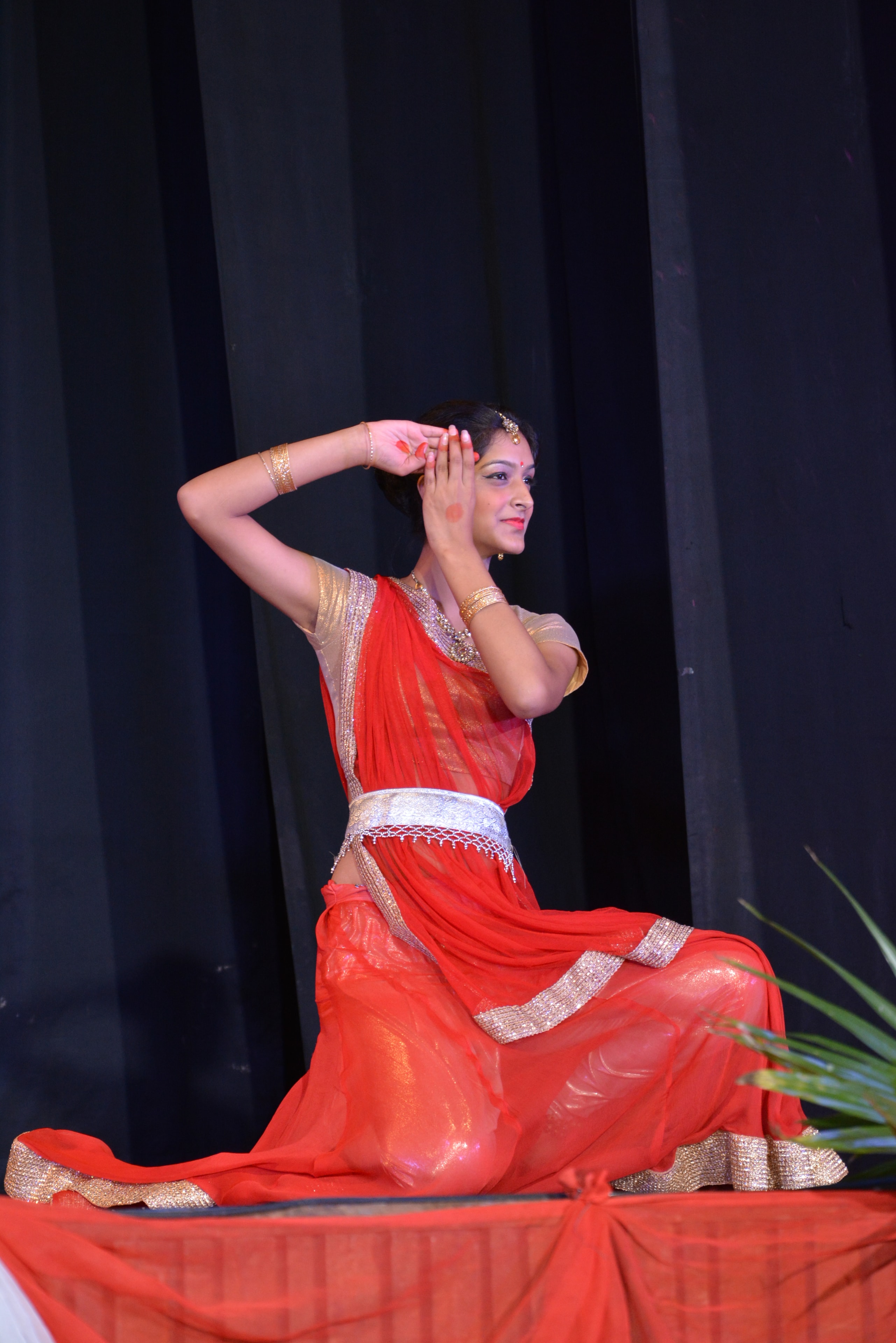 Solo dancer in red seated pose at Nritya Utsav 2014