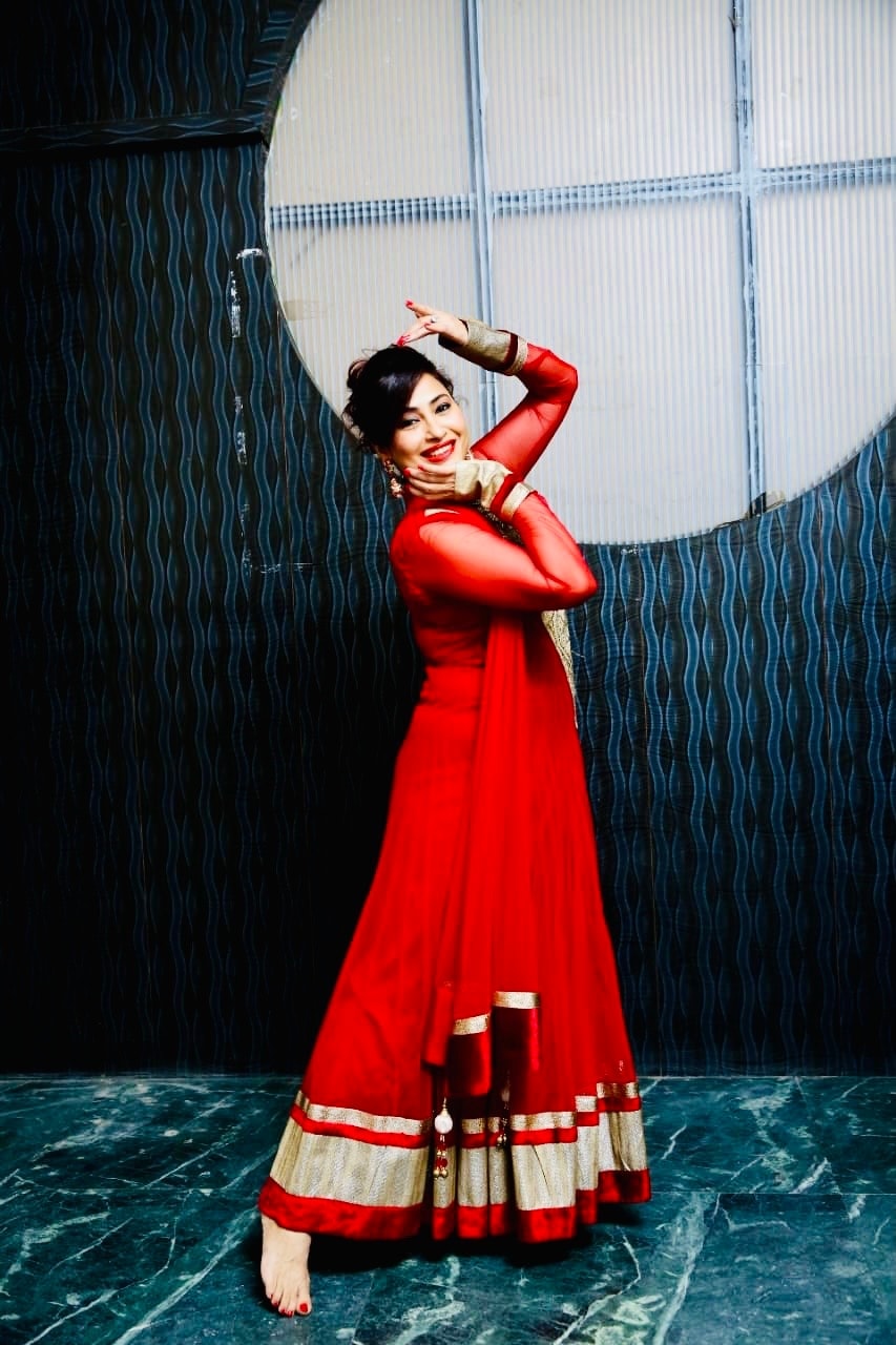 Dancer in red classical dress posing gracefully