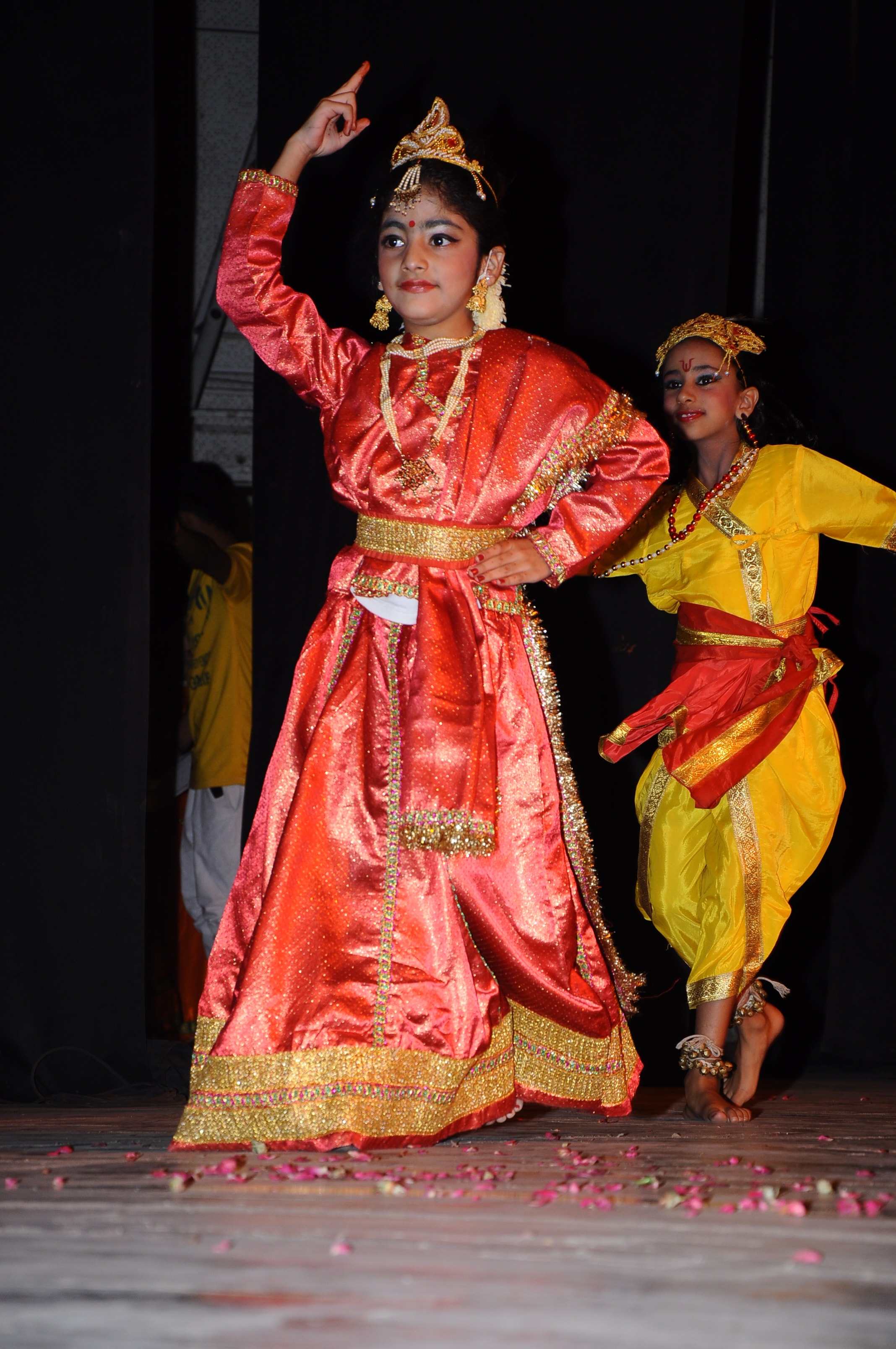 Students in red and gold classical dance costumes