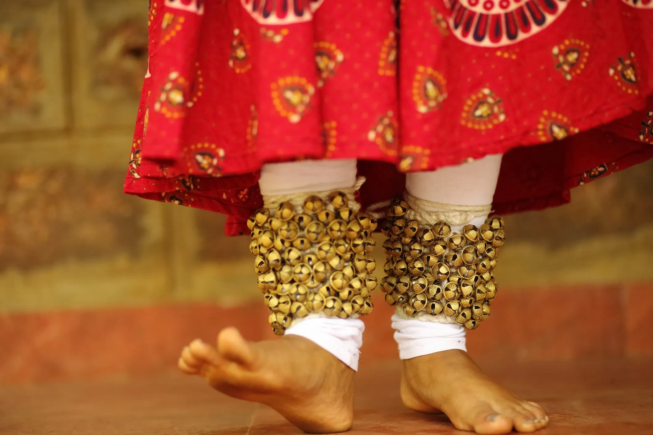 Kathak dancer in classical red costume with bells