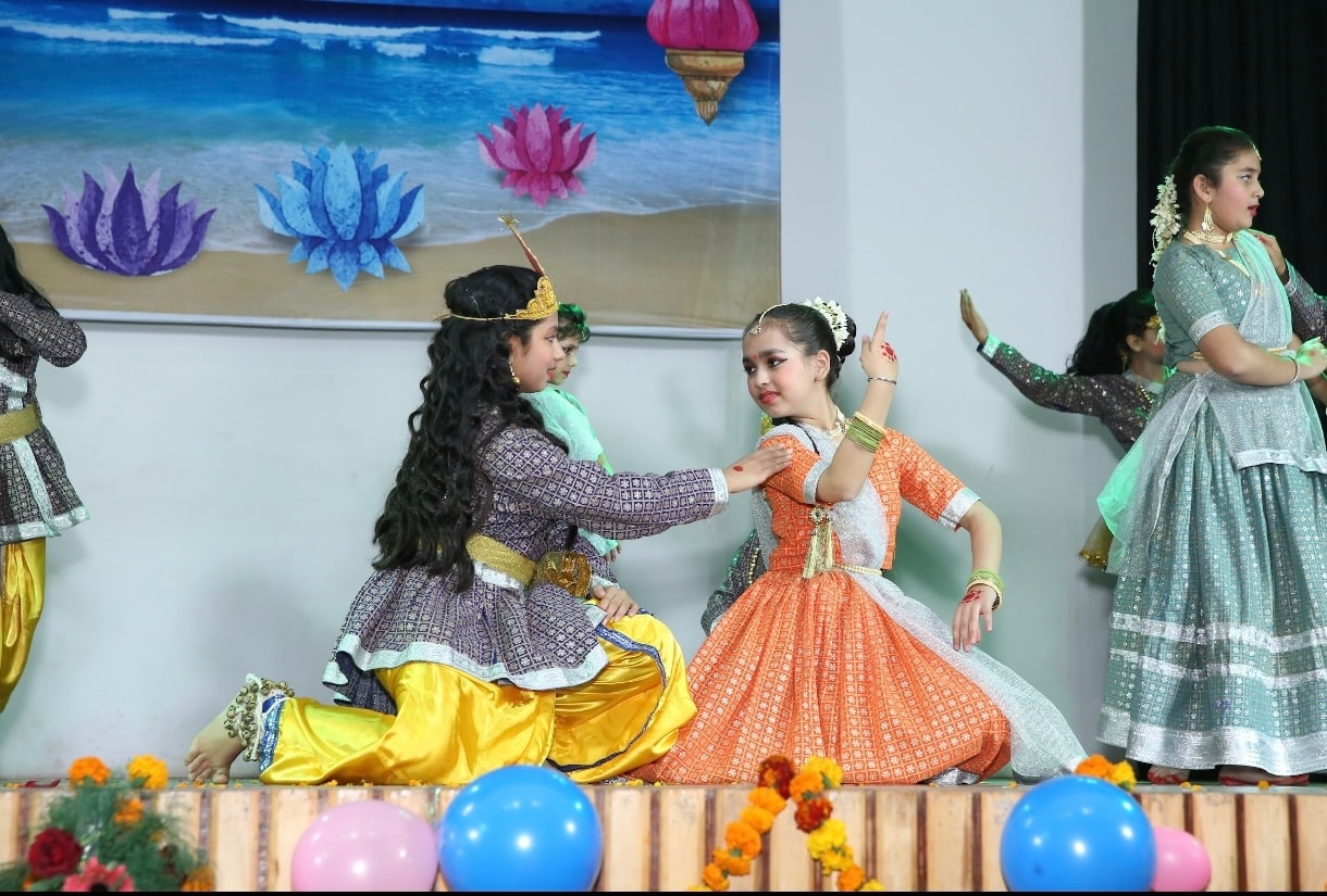 Children performing Krishna Radha themed dance on colorful stage